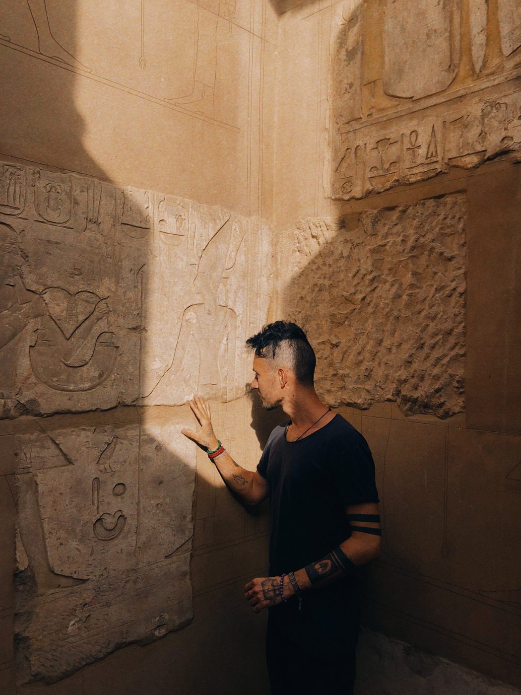 Andrei touching a carved temple wall in Egypt